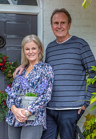 GIBBONS_CROFT_WEST_CLANDON_SURREY_OWNERS_BRUCE_AND_LOUISE_STEWART_BY_THE_FRONT_DOOR