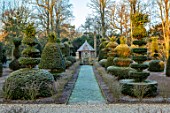 MALVERLEYS, HAMPSHIRE: WINTER, FROST, FROSTY, PATHS, CLIPPED, YOPIARY, YEW, SHAPES, RAISED CHICKEN HOUSE, FORMAL, COUNTRY, GARDEN, DWARF, HEDGING, HEDGES, EUONYMUS ALATUS COMPACTUS