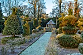 MALVERLEYS, HAMPSHIRE: WINTER, FROST, FROSTY, PATHS, CLIPPED, YOPIARY, YEW, SHAPES, RAISED CHICKEN HOUSE, FORMAL, COUNTRY, GARDEN, DWARF, HEDGING, HEDGES, EUONYMUS ALATUS COMPACTUS