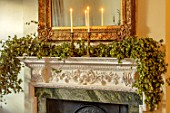 MARBURY HALL, SHROPSHIRE: DESIGNER SOFIE PATON-SMITH - DINING ROOM, VICTORIAN INSPIRED CHRISTMAS, MANTELPIECE WITH CANDLES, HOPS, MIRROR
