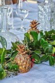 MARBURY HALL, SHROPSHIRE: DESIGNER SOFIE PATON-SMITH - SWEDISH CHRISTMAS, PALE BLUE DINING ROOM,  TABLE DECORATIONS WITH PINEAPPLES AND HOLLY