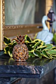 MARBURY HALL, SHROPSHIRE: DESIGNER SOFIE PATON-SMITH - SWEDISH CHRISTMAS, PALE BLUE DINING ROOM, DECORATION ON MANTELPIECE WITH PINEAPPLES AND HOLLY