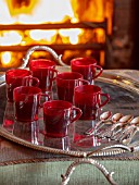 MARBURY HALL, SHROPSHIRE: DESIGNER SOFIE PATON-SMITH - THE LIBRARY, RED, CHRISTMAS, HEATED GLOG OR GLUE WEIN ON TRAY IN FRONT OF FIRE