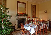 MARBURY HALL, SHROPSHIRE: DESIGNER SOFIE PATON-SMITH - TAPESTRY DINING ROOM, SWEDISH CHRISTMAS - LUNCH SERVED IN HOME MADE STRAW BASKET , CANDLES, CHRISTMAS TREE, MIRROR