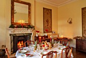 MARBURY HALL, SHROPSHIRE: DESIGNER SOFIE PATON-SMITH - TAPESTRY DINING ROOM, SWEDISH CHRISTMAS - LUNCH SERVED IN HOME MADE STRAW BASKET , CANDLES, MIRROR