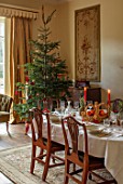 MARBURY HALL, SHROPSHIRE: DESIGNER SOFIE PATON-SMITH - TAPESTRY DINING ROOM, SWEDISH CHRISTMAS - LUNCH SERVED IN HOME MADE STRAW BASKET , CANDLES, CHRISTMAS TREE, MIRROR