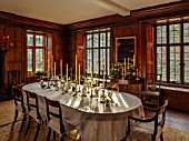 WARDINGTON MANOR, OXFORDSHIRE: FLORIST SHANE CONNOLLY - DINING ROOM: DINING TABLE, WHITE TABLECLOTH, CANDLES, SILVER VASES WITH CHRISTMAS ROSE, HELLEBORES, INDOOR, FLOWERS