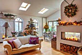 MERRYWOOD, JACKY HOBBS HOUSE, LONDON: CHRISTMAS, SITTING ROOM, CHRISTMAS TREE, SLEDGE, SOFA, LOG BASKET, NATURAL WREATH