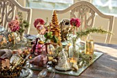 MERRYWOOD, JACKY HOBBS HOUSE, LONDON: SITTING ROOM - DINING AREA, WOODEN DINING TABLE, CANDLES, METAL CROWNS, CHRISTMAS TREE, PLACE SETTINGS, METAL GOBLETS, DRIED PEONY AND ROSES