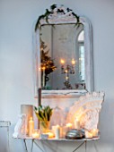 MERRYWOOD, JACKY HOBBS HOUSE, LONDON: DINING ROOM - VINTAGE FRENCH MIRROR, VINTAGE FRENCH METAL GARDEN TABLE, VINTAGE PLASTER ARTEFACTS, WHITE CANDLES, WHITE TULIPS IN VASE