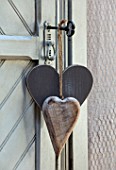MERRYWOOD, JACKY HOBBS HOUSE, LONDON: CARVED WOODEN HEARTS ON OLD KEY ON VINTAGE FRENCH GREY PAINTED CUPBOARD