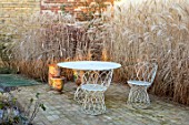 THE OLD RECTORY, QUINTON, NORTHAMPTONSHIRE: DESIGNER ANOUSHKA FEILER: FROST, WINTER, TABLE, CHAIRS, MISCANTHUS SINENSIS KLEINE FONTAINE, PATIOS, CONTAINERS