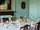 MARBURY HALL, SHROPSHIRE: DESIGNER SOFIE PATON-SMITH, BLUE DINING ROOM, WHITE TABLE CLOTH, SPRING FLOWERS IN VASES, HELLEBORES, DAFFODILS, ANEMONES