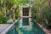 TAROUDANT, MOROCCO: DESIGNERS ARNAUD MAURIERES AND ERIC OSSART: DAR AL HOSSOUN - VIEW ALONG POOL, CANAL, REFLECTIONS, REFLECTED, SUCCULENTS