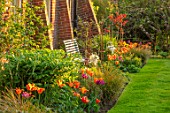 THE COACH HOUSE, SURREY, DESIGNER BARBARA BROOKS: LAWN, PATH, BORDERS WITH TULIPS, WHITE BENCH, SEAT, WALL, SPRING, GARDEN, TULIPA BALLERINA, HOLLYWOOD, NIGHTRIDER