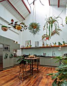 JAMIES JUNGLE, LONDON HOUSE OF JAMIE SONG: APARTMENT FILLED WITH HOUSEPLANTS. INDOORS, GREEN INTERIORS, FOLIAGE, KITCHEN