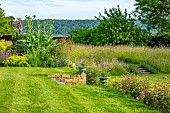ROOKERY FARM, SURREY: LAWN, CONTAINERS, URNS, MEADOW, ROSES, GARDENS, ENGLISH, COUNTRY, SUMMER. ROSA BOSCOBEL, AUSCOUSIN