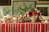 THE LAND GARDENERS, WARDINGTON MANOR, OXFORDSHIRE: CONSTANCE SPRY VASES WITH ROSES ON STRIPEY TABLECLOTH. STILL LIFE, FLOWER ROOM, CUTTING, FLOWERS