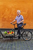 CLAUS DALBY GARDEN, DENMARK: CLAUS DALBY ON A BIKE WITH VEGETABLES