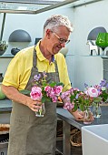 CLAUS DALBY GARDEN, DENMARK: CLAUS PREPARING FLOWERS IN HIS OUTDOOR KITCHEN