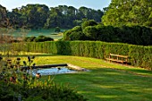 THE NEWT IN SOMERSET: SQUARE POOL, WOODEN BENCH, SEAT, YEW TOPIARY CLOUD HEDGING, HEDGES, THE LONG WALK, JULY