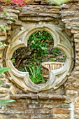 ADAMS POOL, GLOUCESTERSHIRE: FOLLY WALL WITH QUATREFOIL RECYCLED CHURCH WINDOW
