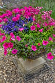ADAMS POOL, GLOUCESTERSHIRE: STONE CONTAINER WITH PINK GERANIUMS