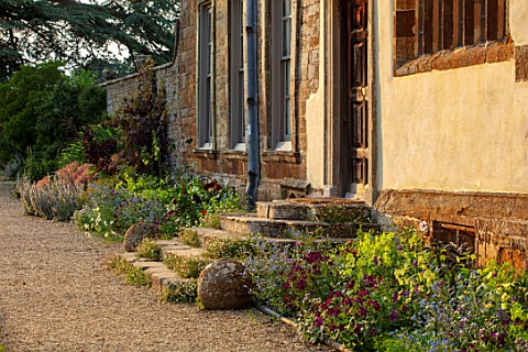CANONS_ASHBY_NORTHAMPTONSHIRE_THE_NATIONAL_TRUST__FRONT_DOOR_BORDERS_NICOTIANA_LIME_GREEN_NICOTIANA_