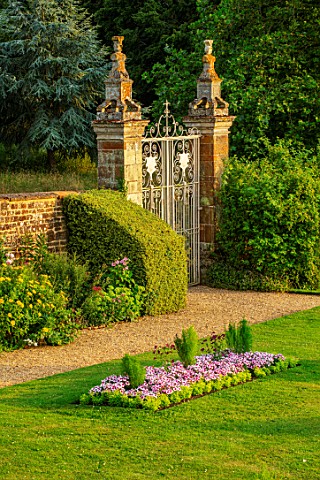CANONS_ASHBY_NORTHAMPTONSHIRE_THE_NATIONAL_TRUST__WALL_GATE_LAWN_BEDDING_BEDS_EVENING_JULY_ENGLISH_C