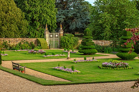 ANONS_ASHBY_NORTHAMPTONSHIRE_THE_NATIONAL_TRUST__LAWN_BEDDING_GRAVEL_PATHS_CLIPPED_TOPIARY_YEWS_WALL