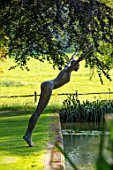 GLYNDEBOURNE, EAST SUSSEX: LAKE, LAWN, SCULPTURE OF DIVING LADY BY CAROL PEACE