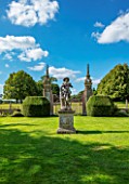 CANONS ASHBY, NORTHAMPTONSHIRE, THE NATIONAL TRUST: GREEN COURT, GATES, YEW TOPIARY, LEAD STATUE OF SHEPHERD BOY FROM A MODEL BY JAN VON NOST