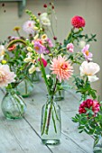 GREEN AND GORGEOUS FLOWERS, OXFORDSHIRE: TABLE ARRANGEMENT OF GLASS VASES FOR WEDDING ALONG GREY, BLUE TABLE - DAHLIAS, FALL, AUTUMN, BLOOMING, BULBS
