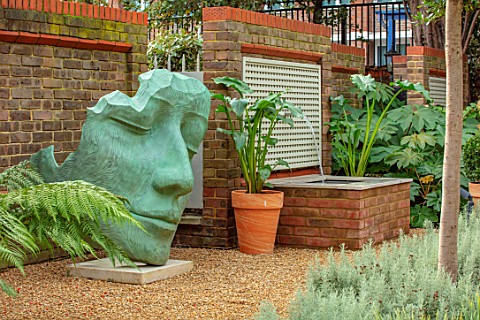 DESIGNER_ANTHONY_PAUL_SMALL_TOWN_FORMAL_GRAVEL_WATER_FEATURE_HEAD_SCULPTURE_WALL_LONDON