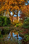 MORTON HALL GARDENS, WORCESTERSHIRE: FALL, AUTUMN, FOLIAGE, COLOURS, THE HALL REFLECTED IN THE POOL, WATER, LAKE, POND, HOUSE, OAK