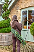 DAYLESFORD ORGANIC, GLOUCESTERSHIRE: GIRL HOLDING HEART, WREATH, CHRISTMAS, DECORATIONS, DECORATIVE, GRAVEL, TWISTED, TOPIARY, CONTAINER, WOODEN, BARREL