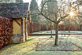 BRYANS GROUND, HEREFORDSHIRE - WINTER GARDEN, FROST, FROSTY, SERPENTINE CANAL, JANUARY, FRUIT TREES, HEDGE, HEDGING, BEECH, GARDEN, BUILDING, SUNRISE