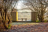BRYANS GROUND, HEREFORDSHIRE: THE LIGHTBOX, CRICKET WOOD, WINTER, WOODLAND, WOODEN BENCH, SEAT, COUNTRY GARDEN, FROST, FROSTY, BORROWED, LANDSCAPE, VIEW, FOCAL POINT