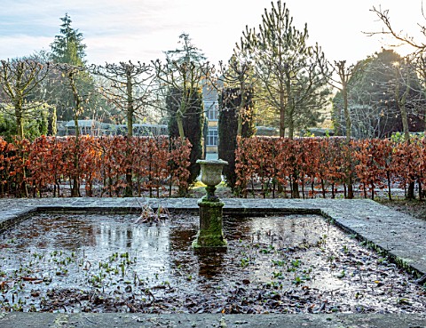 BRYANS_GROUND_HEREFORDSHIRE_FROZEN_POOL_POND_CONTAINER_STONE_URN_BEECH_HEDGES_HEDGING_WINTER_COUNTRY