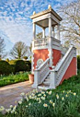 THE LASKETT GARDENS, HEREFORDSHIRE. DESIGNER ROY STRONG - BELVEDERE VIEWING PLATFORM, FOLLY, FOLLIES, BUILDINGS, BALUSTRADE, NARCISSUS, DAFFODILS, STAIRS, SPRING, APRIL