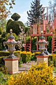THE LASKETT GARDENS, HEREFORDSHIRE. DESIGNER ROY STRONG - THE HOWDAH COURT, MALUS FLORIBUNDA, CLIPPED TOPIARY YEW, FORMAL GARDEN, APRIL, SPRING, URNS, CONTAINERS, VIEWING PLATFORM