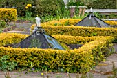 THE LASKETT GARDENS, HEREFORDSHIRE. DESIGNER ROY STRONG - THE HOWDAH COURT, CLIPPED TOPIARY, FORMAL GARDEN, APRIL, SPRING, WATER FEATURE