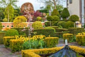 THE LASKETT GARDENS, HEREFORDSHIRE. DESIGNER ROY STRONG - THE HOWDAH COURT, MALUS FLORIBUNDA, TULIPS, CLIPPED TOPIARY, FORMAL GARDEN, APRIL, SPRING, WATER FEATURES