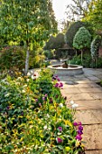 MORTON HALL GARDENS, WORCESTERSHIRE: TULIPS AND FOUNTAIN IN THE SOUTH GARDEN, APRIL, SPRING, PATHS, MORNING LIGHT