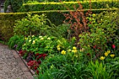 MORTON HALL GARDENS, WORCESTERSHIRE: KITCHEN GARDEN, YELLOW TULIPS, APRIL, SPRING, TULIPA YELLOW SPRING GREEN, PEONY, PAEONIA MLOKOSEWITSCHII, MOLLY THE WITCH, FLOWERING, BLOOMING