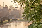 FORDE ABBEY, SOMERSET: ABBEY AND LAKE IN EARLY MORNING LIGHT, DAWN, SPRING, APRIL, MIST, FOG
