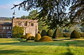 FORDE ABBEY, SOMERSET: THE ABBEY AT DAWN, MORNING LIGHT, SUNRISE, APRIL, SPRING, YEW, CLIPPED, TOPIARY