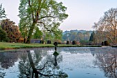 FORDE ABBEY, SOMERSET: LAKE AND STATUE IN EARLY MORNING SUNSHINE, DAWN, APRIL, SPRING, WATER, POOL, REFLECTED, REFLECTIONS