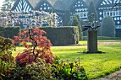 HALL O TH WOOD, CHESHIRE: HOUSE, LAWN, SPRING, APRIL, CLIPPED, TOPIARY, SHAPES, GREEN, YEW, TAXUS, MAPLE, ACERS, SCULPTURE ON LAWN