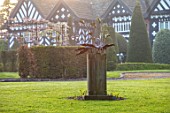 HALL O TH WOOD, CHESHIRE: HOUSE, LAWN, SPRING, APRIL, CLIPPED, TOPIARY, SHAPES, GREEN, YEW, TAXUS, MAPLE, ACERS, SCULPTURE ON LAWN